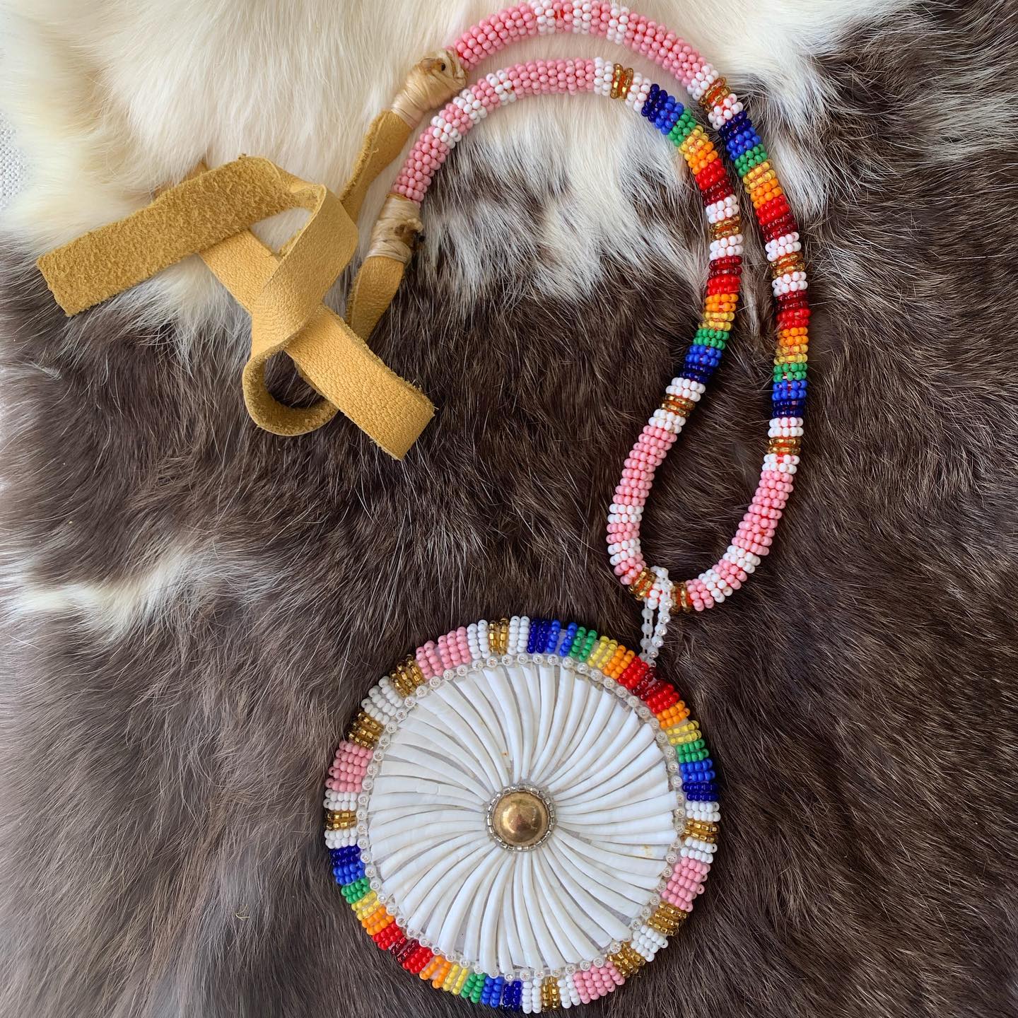 Pink dentalium round medallion on a pink and rainbow beaded rope. This is one of my all time favourites!