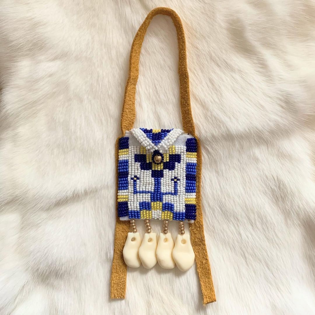 This beaded baby belt pouch is just big enough to hold a tiny tots payout. Complete with a hide strap and imitation elk teeth.